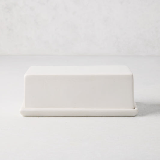 White ceramic butter dish with a sleek rectangular lid and tray.