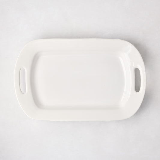 White ceramic serving platter with handles, 11"W x 18"L, from HG Ceramic Medium collection.