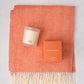 HG Comfy Day Bundle: Mandarin orange Italian herringbone throw with fringe, HG scented candle, and candle box.