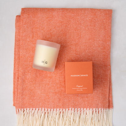 HG Comfy Day Bundle: Mandarin orange Italian herringbone throw with fringe, HG scented candle, and candle box.