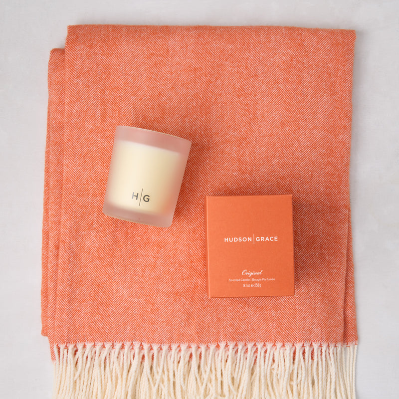 HG Comfy Day Bundle: Mandarin orange Italian herringbone throw with fringe, HG scented candle, and candle box.
