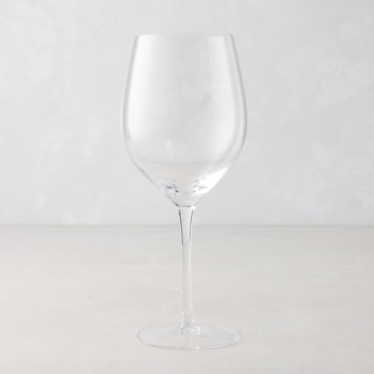 Clear, tall HG Heritage mouth-blown wine glass with a thin stem and wide bowl.