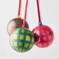 Three HG Jolly Gingham Baubles: hand-painted, mouth-blown glass, 3"Dia. Red, green, and pink plaid.