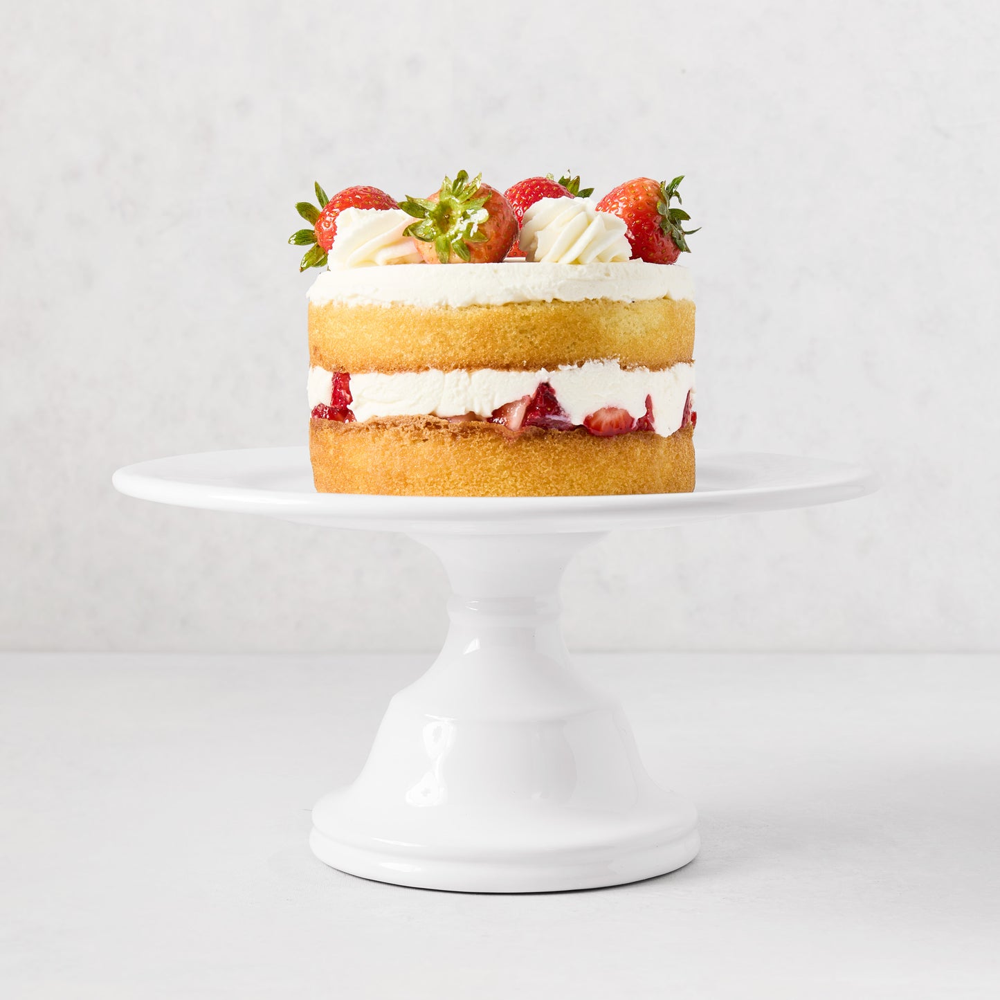 HG Original Small Pedestal Cake Stand, creamy white ceramic, 10.5" Dia, with strawberry cake.