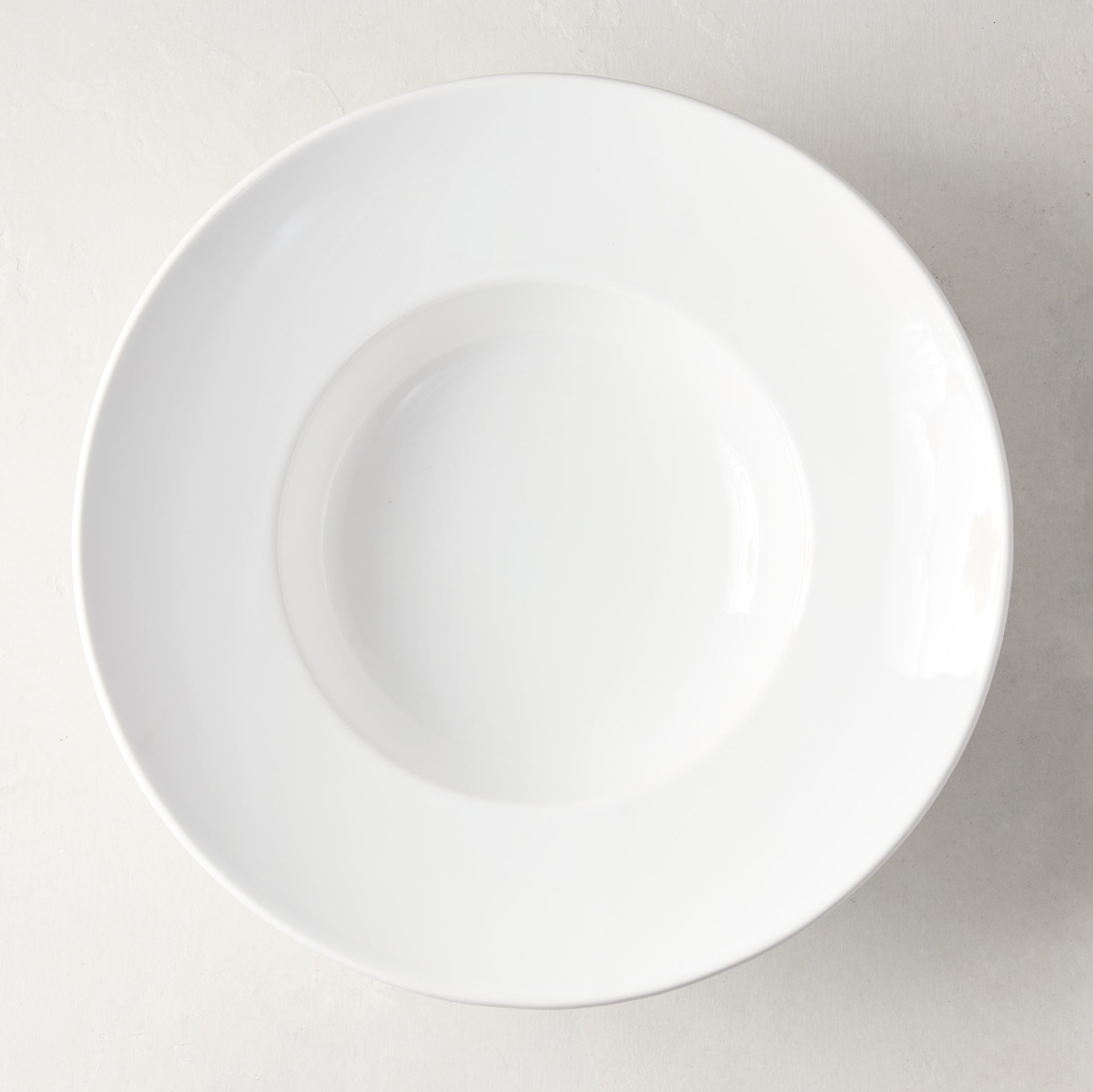 White ceramic wide-rim soup bowl, 9" diameter, top-down view.