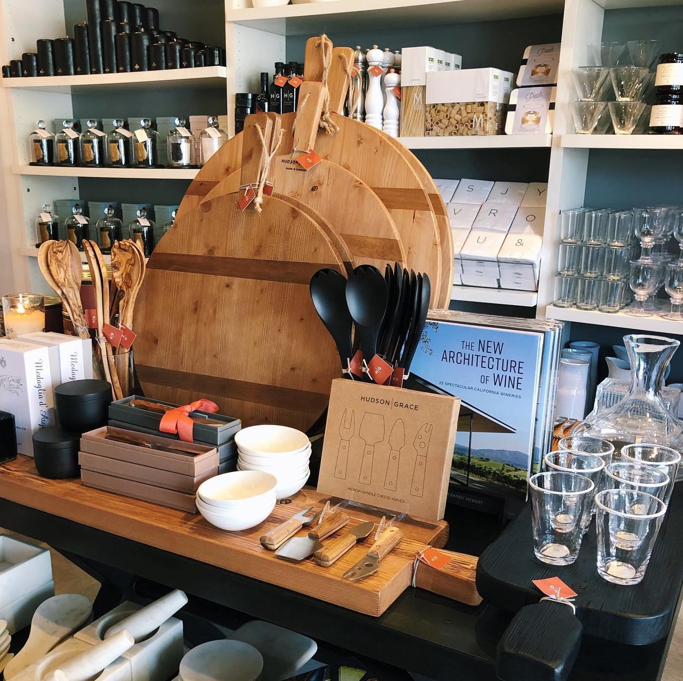 Three round HG Reclaimed Wood serving boards in varying sizes, displayed with kitchenware.
