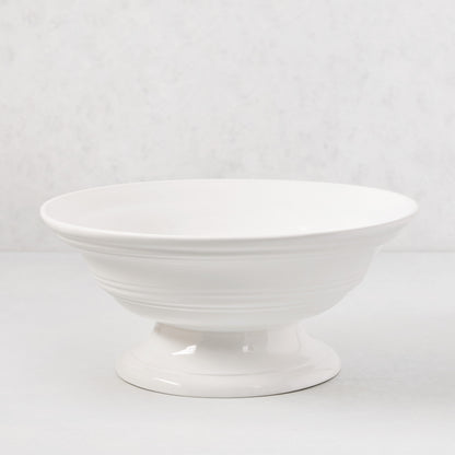 White ceramic footed bowl, 11.5" round, with a smooth glaze and subtle horizontal ridges.