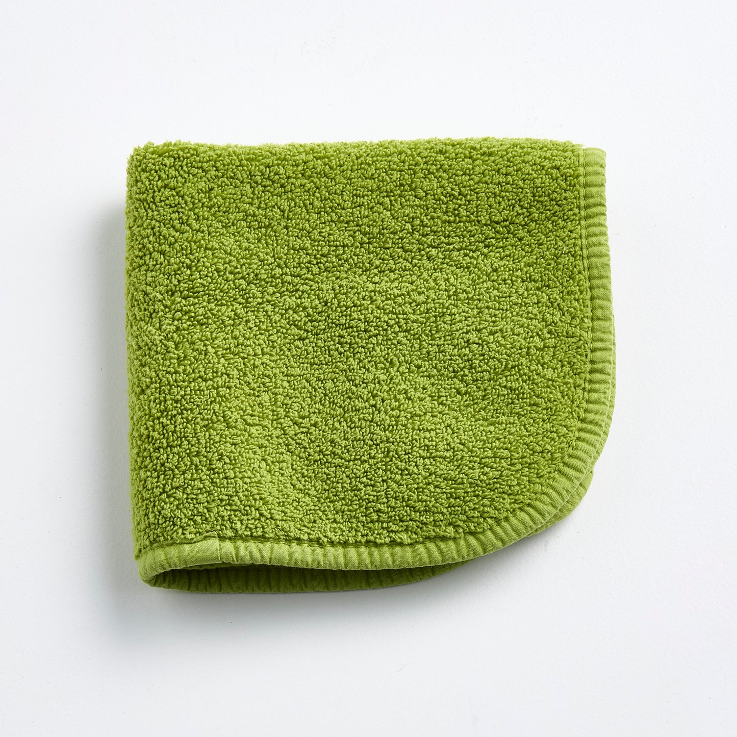 Aloe green 12-inch square zero-twist cotton terry washcloth with matching bias piping.
