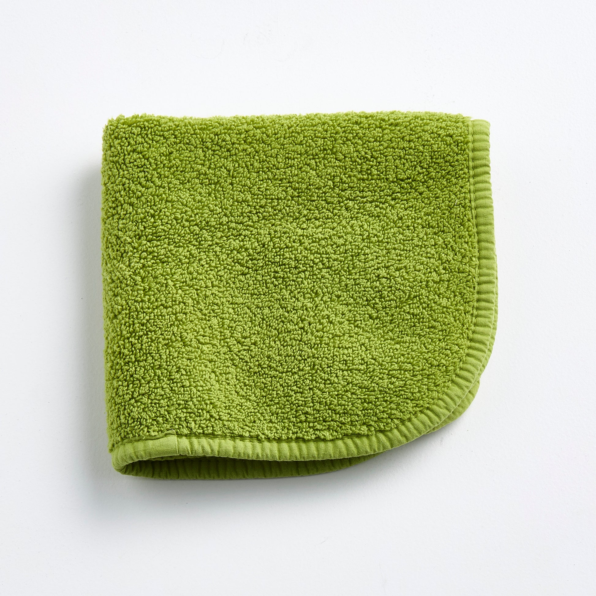 Aloe green 12-inch square zero-twist cotton terry washcloth with matching bias piping.