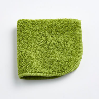 Aloe green 12-inch square zero-twist cotton terry washcloth with matching bias piping.