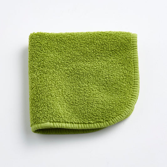 Aloe green 12-inch square zero-twist cotton terry washcloth with matching bias piping.