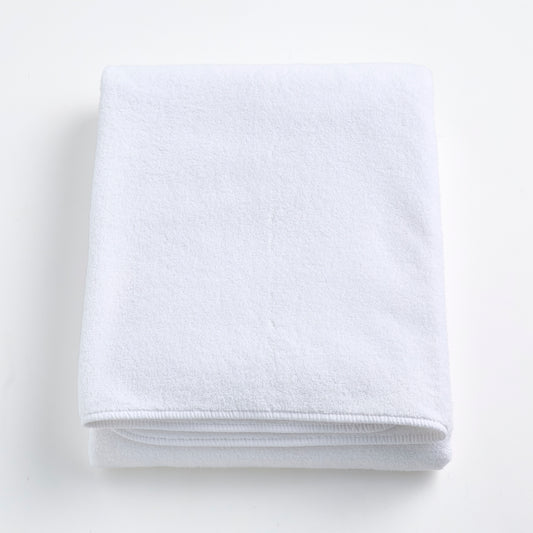 Folded cloud white Signature bath sheet made of plush, absorbent cotton terry fabric.