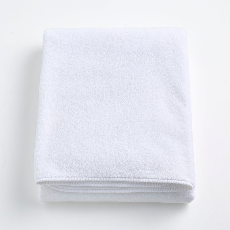 Folded cloud white Signature bath sheet made of plush, absorbent cotton terry fabric.