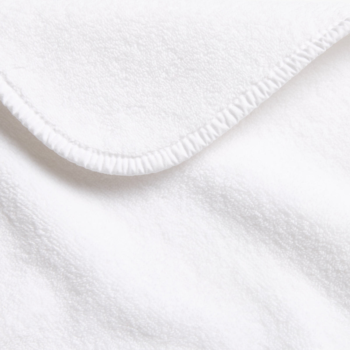 Cloud white Signature hand towel featuring soft cotton terry fabric with a finished stitched edge.