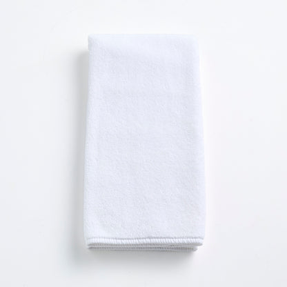 Cloud white Signature hand towel made of soft, folded cotton terry fabric on a clean white background.