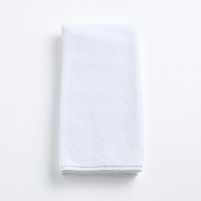 Cloud white Signature hand towel made of soft, folded cotton terry fabric on a clean white background.