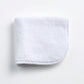Cloud white Signature washcloth in soft, absorbent terry cotton with rounded corners and a finished piped edge.