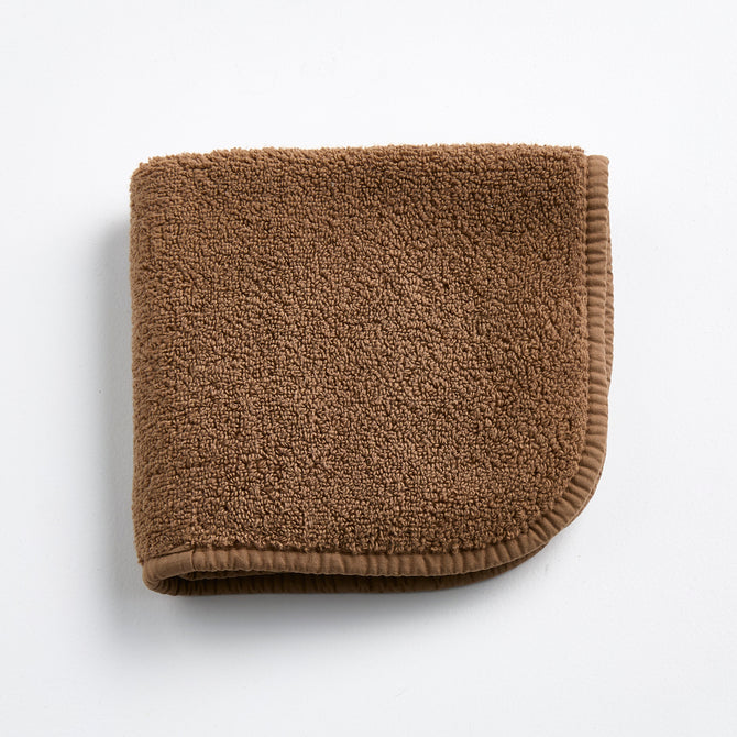 Coffee brown Signature washcloth made of soft, absorbent cotton terry with a finished stitched border.