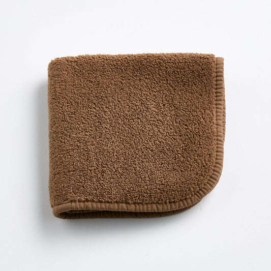 Coffee brown Signature washcloth made of soft, absorbent cotton terry with a finished stitched border.