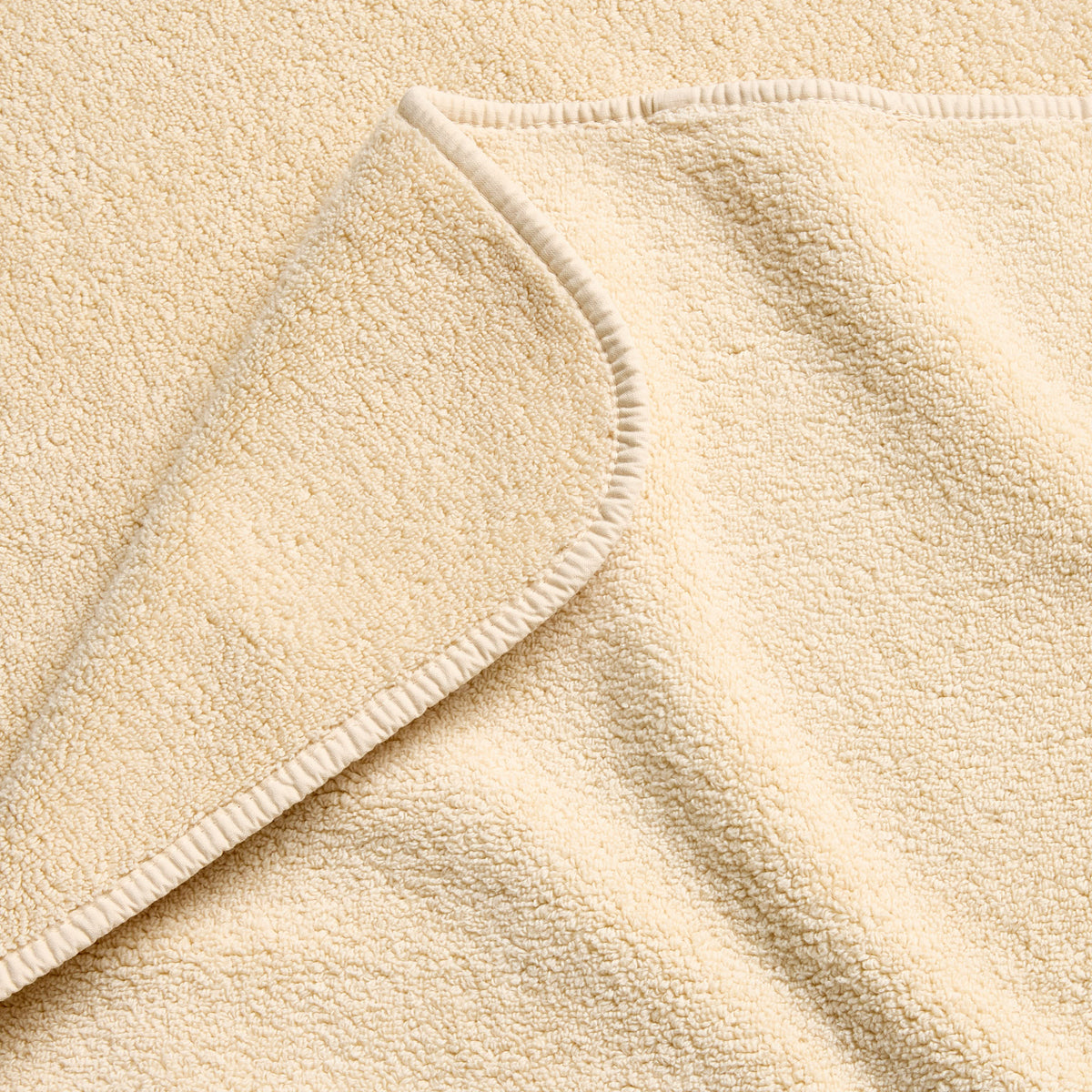 Creme brulee signature bath towel with a soft, plush terry texture and finished with a clean, stitched hem.