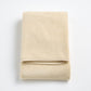 Folded Signature bath towel in creme brulee beige with a plush, textured cotton weave and finished edges.