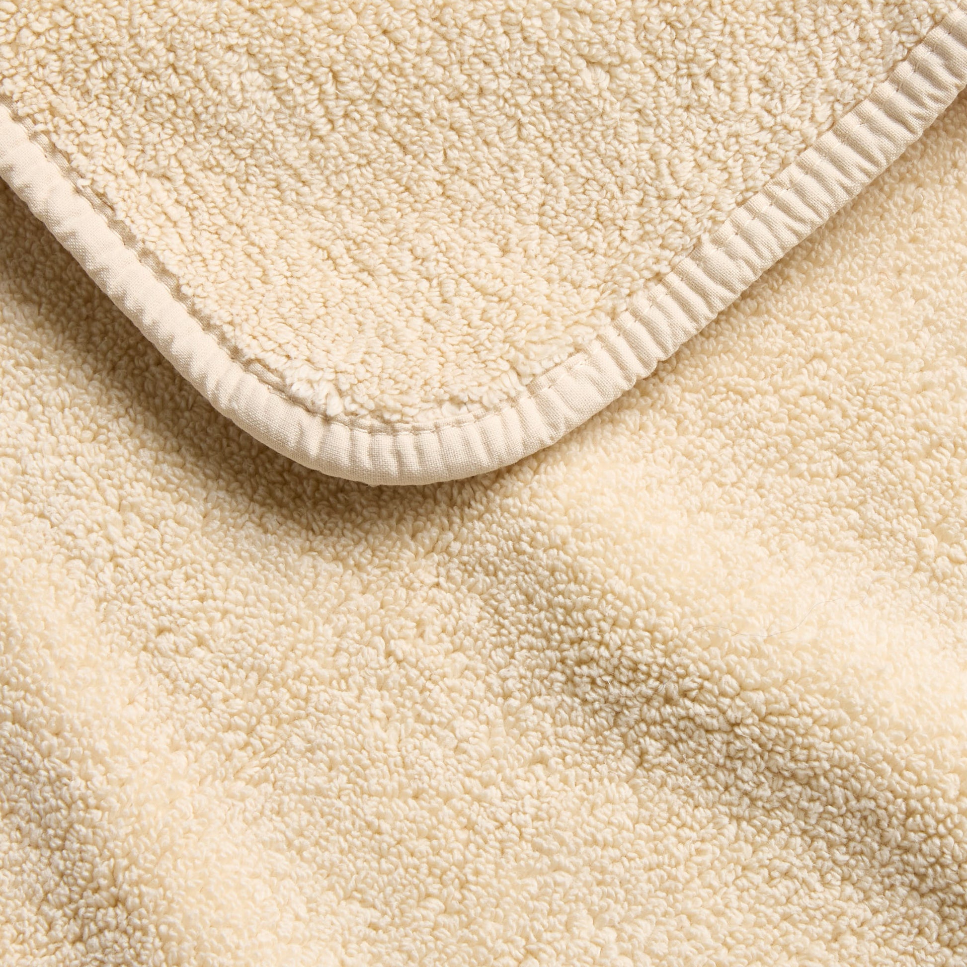 Creme Brulee signature hand towel with a soft, textured terry cloth finish and a clean, stitched hem border.