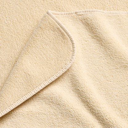 Creme Brulee signature hand towel in soft, textured cotton terry with a finished hemmed edge.