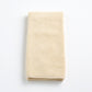 Folded creme brulee signature hand towel in soft, textured cotton terry cloth on a white background.