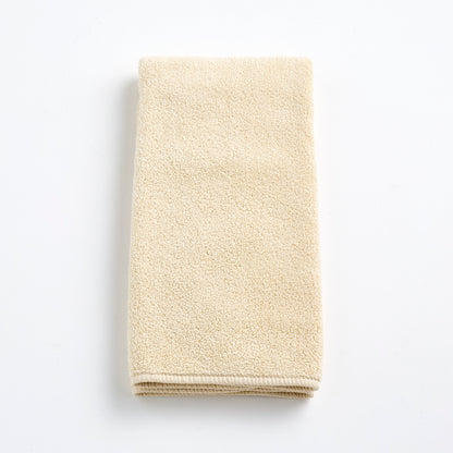 Folded creme brulee signature hand towel in soft, textured cotton terry cloth on a white background.