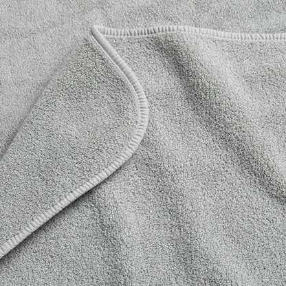 Mist blue Signature hand towel with a soft, plush cotton terry texture and a finished hemmed edge.
