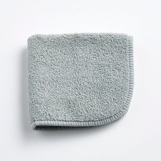 Mist blue Signature washcloth in soft, textured cotton terry with a finished fabric edge on a white background.