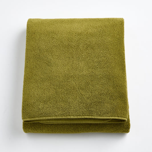Folded olive green HG Signature bath sheet made of zero-twist cotton with matching bias piping.
