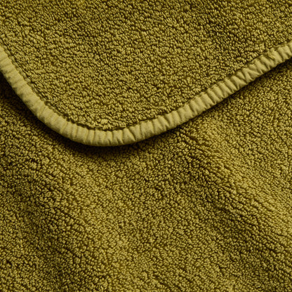 Olive green zero-twist cotton bath towel with matching bias piping detail.