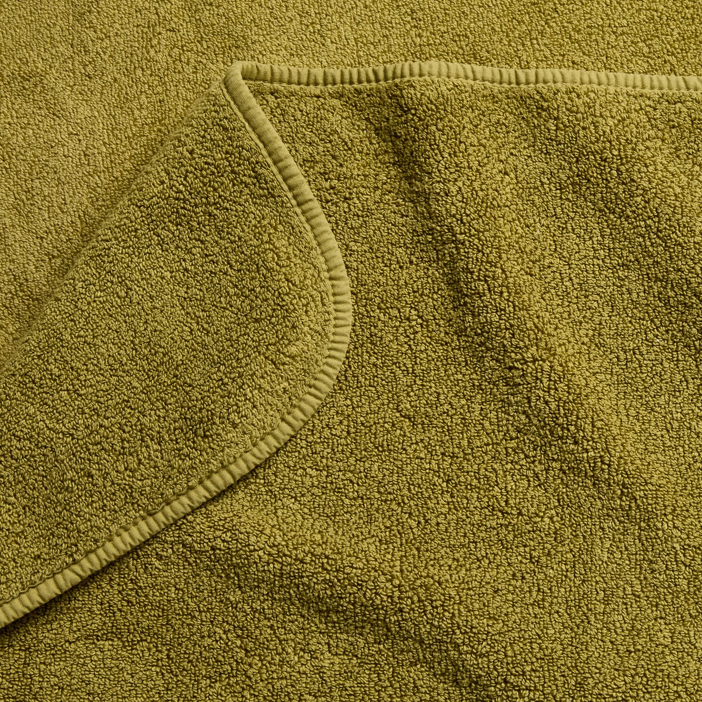 Olive green zero-twist cotton bath towel with matching bias piping detail.