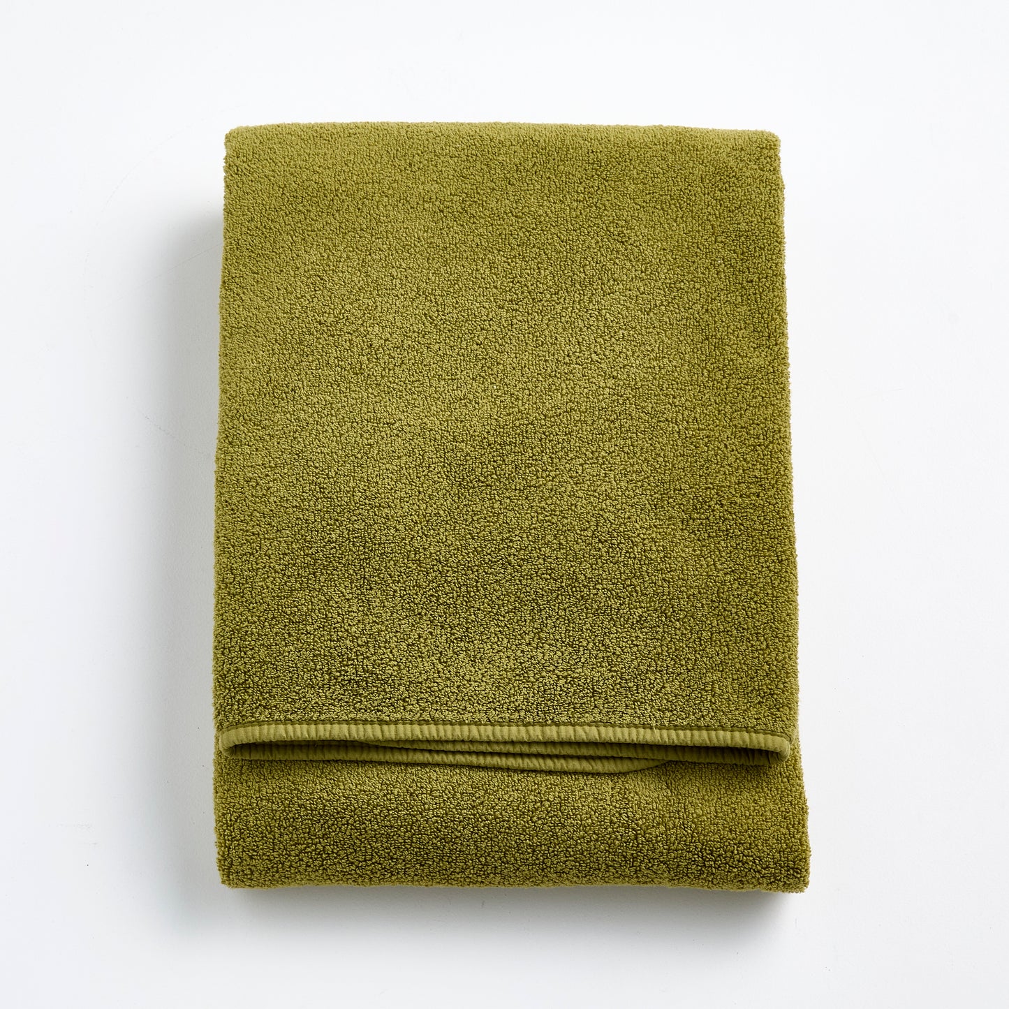 Folded olive green zero-twist cotton bath towel with matching bias piping, 30 by 56 inches.