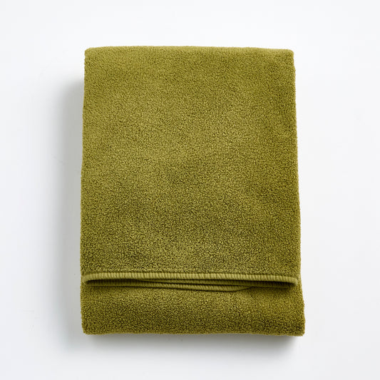 Folded olive green zero-twist cotton bath towel with matching bias piping, 30 by 56 inches.