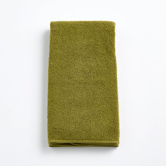 Olive green zero-twist cotton hand towel, 20x30 inches, featuring textured terry fabric and finished bias piping.