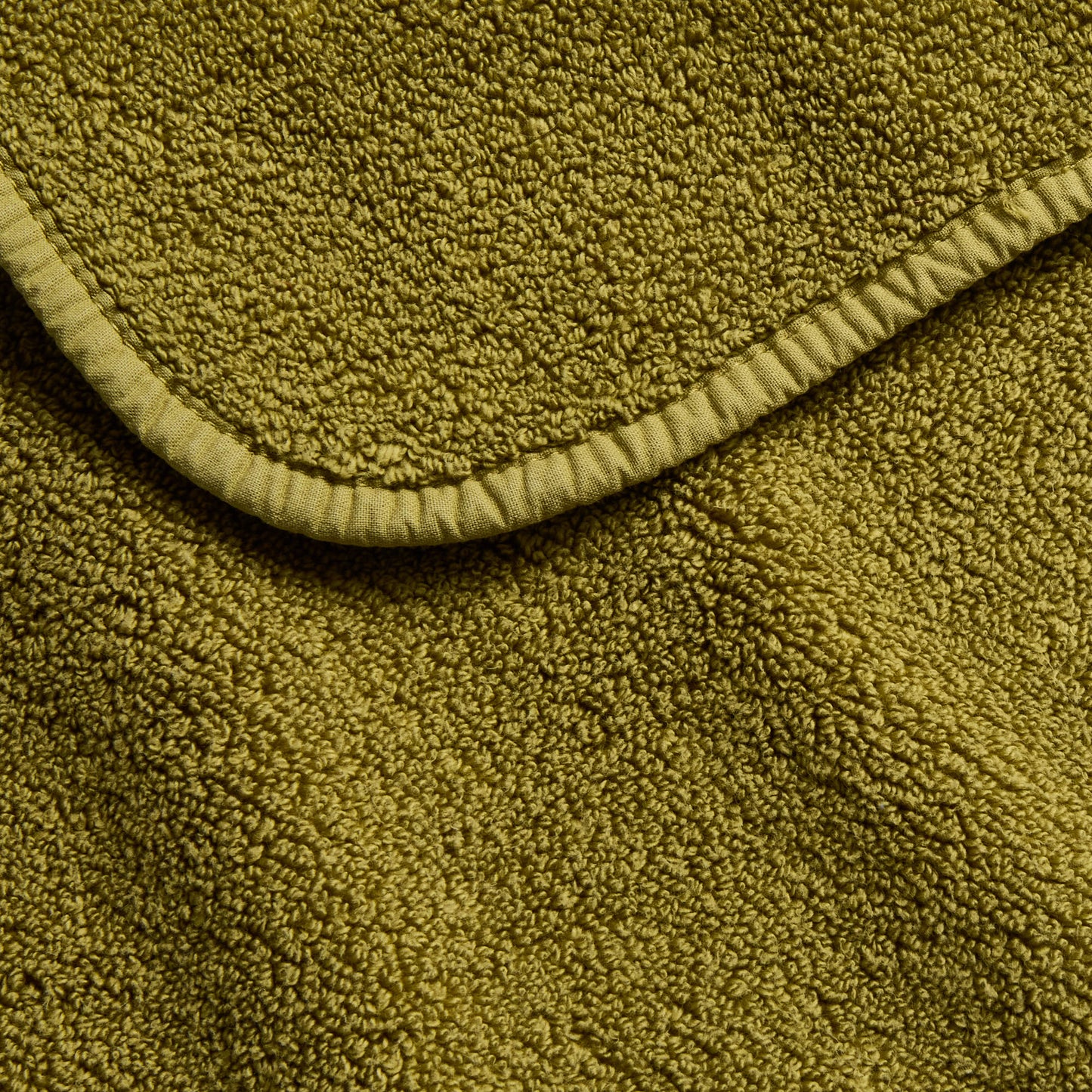 Olive green 12-inch square zero-twist cotton washcloth with matching cotton bias piping trim.