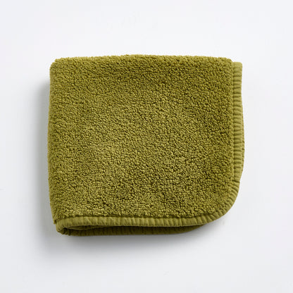 Olive green 12-inch square washcloth made of zero-twist cotton terry with matching cotton bias piping.