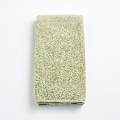 Sage green Signature hand towel made of soft, textured cotton terry cloth, folded neatly on a white background.