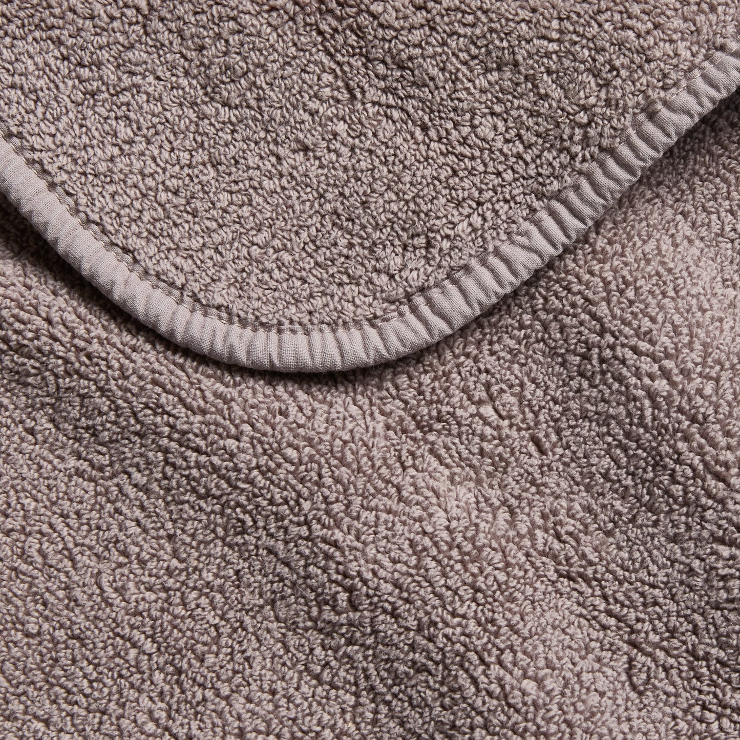 Stone gray Signature bath sheet with a plush, textured cotton terry weave and a finished hemmed edge.