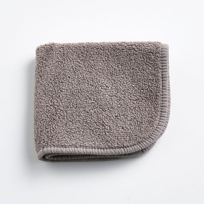 Stone grey HG Signature washcloth in a soft, textured cotton terry fabric with a finished stitched border.