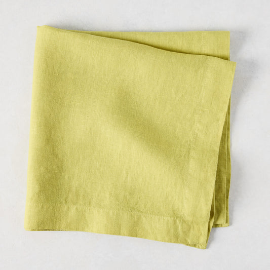 HG Sour Apple hand-dyed linen napkin, 22-inch square, folded on a light background.