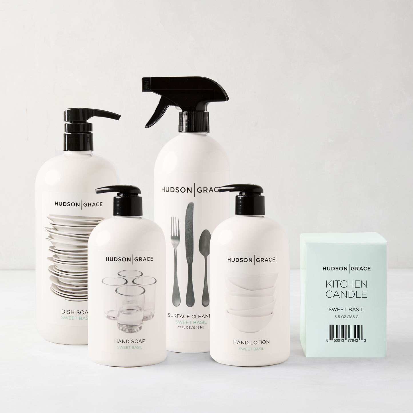 HG Sweet Basil Cleaning Gift Set: white bottles with black pumps, kitchen candle.