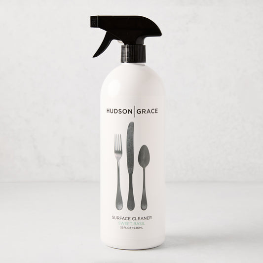 HG Sweet Basil Surface Cleaner, 32oz white spray bottle with black top and cutlery graphic.
