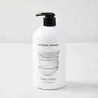 White HG Tart Kumquat Hand Lotion, 16 oz, with black pump and stacked bowls design.