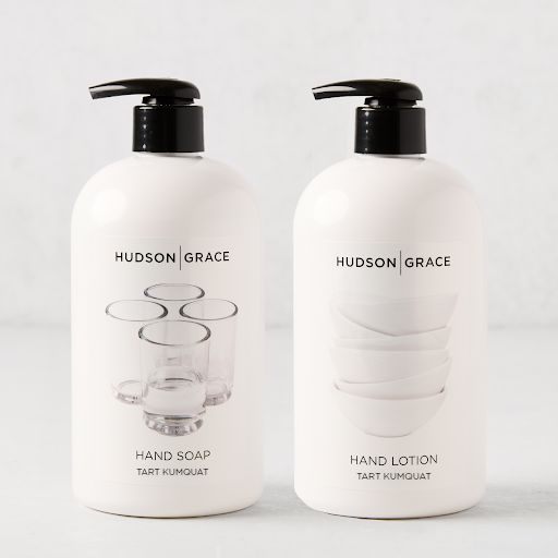 White Hudson Grace Tart Kumquat Hand Soap and Lotion set with black pumps, featuring glass cups and bowls.