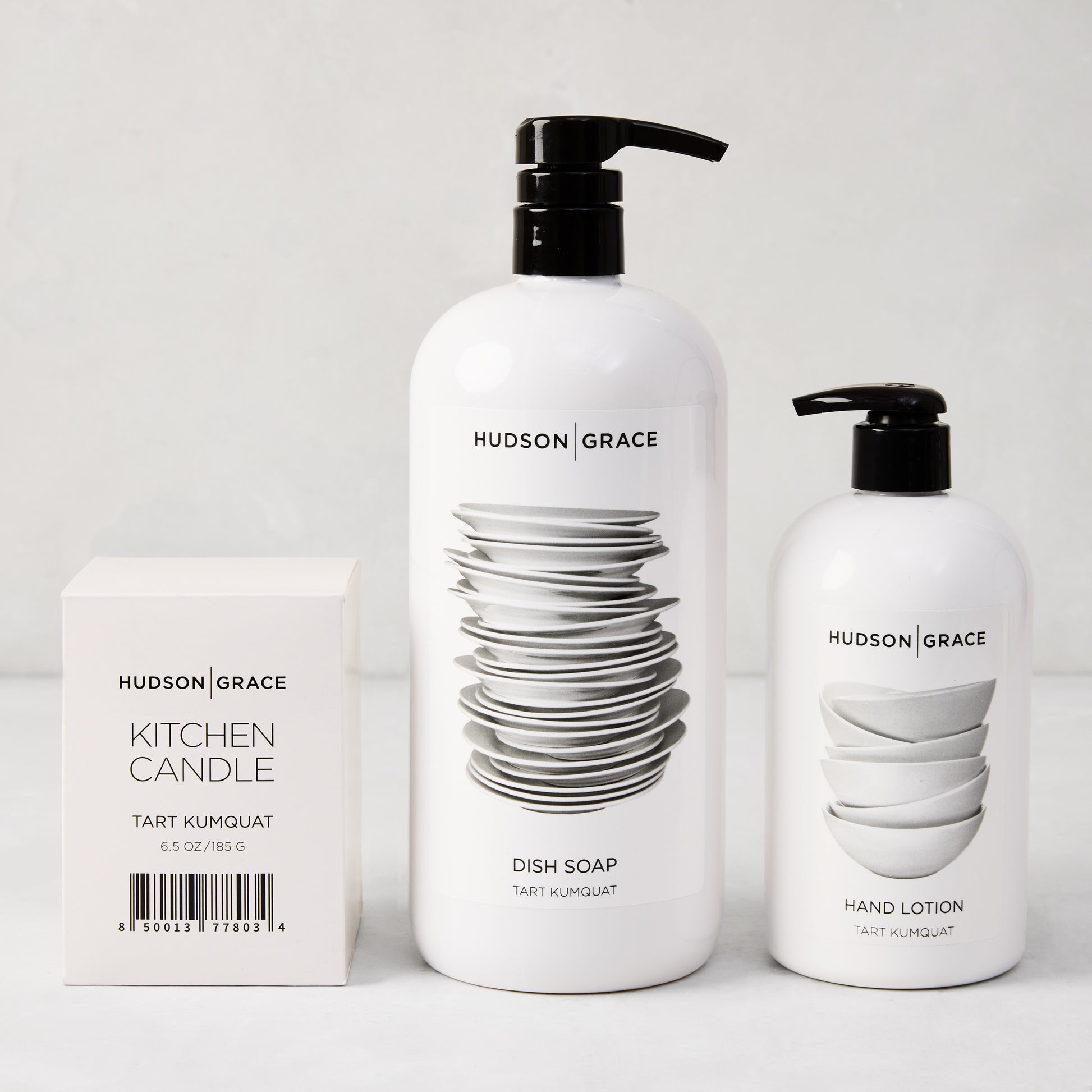 Hudson Grace Tart Kumquat cleaning gift set: white candle box, large dish soap, and smaller hand lotion.