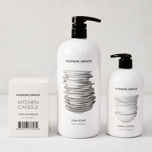 Hudson Grace Tart Kumquat cleaning gift set: white candle box, large dish soap, and smaller hand lotion.