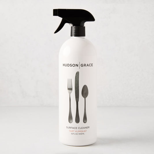 White HG Tart Kumquat Surface Cleaner spray bottle with black top and flatware graphic, 32 oz.